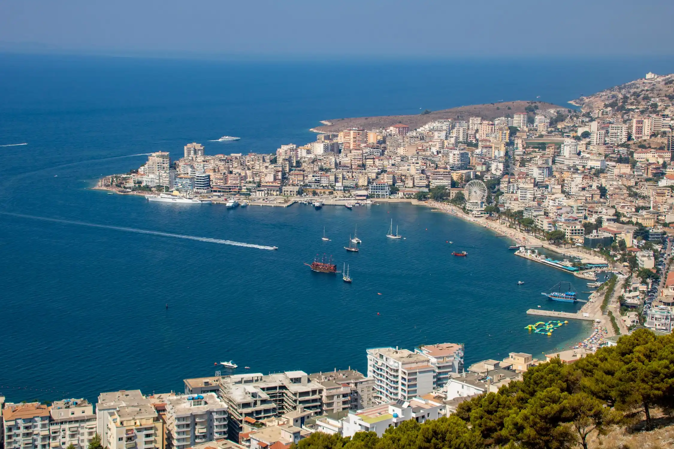 Aerial view of Saranda bay, its seafront and boats in the harbour on the Albanian Riviera